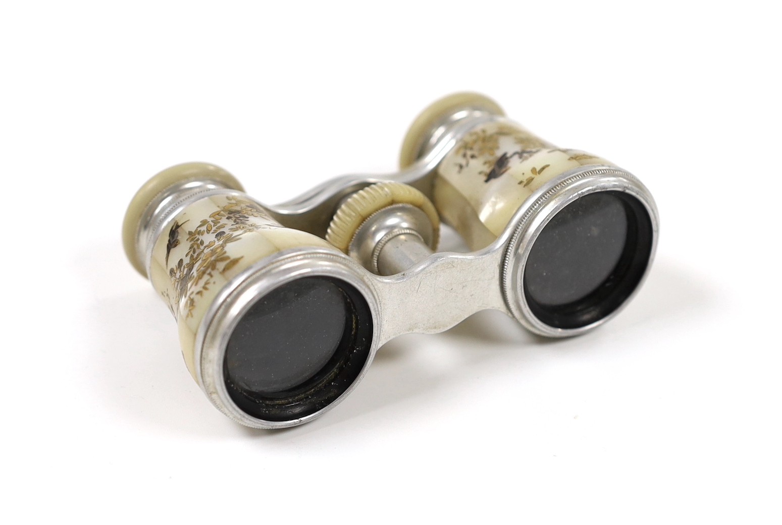A pair of Victorian silvered metal opera glasses, with shibayama inlaid mother o'pearl lens barrels, 10cm wide